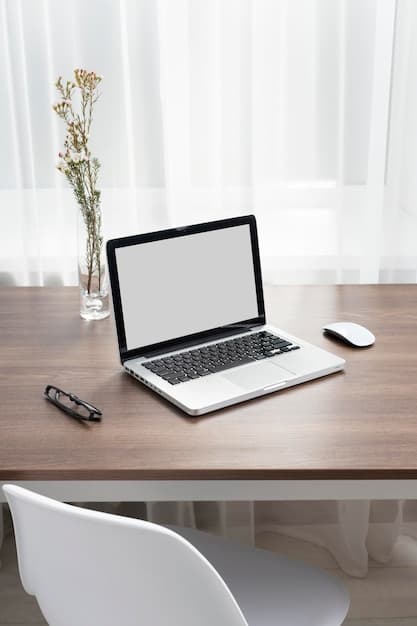 Laptop and vase on a minimal wooden desk